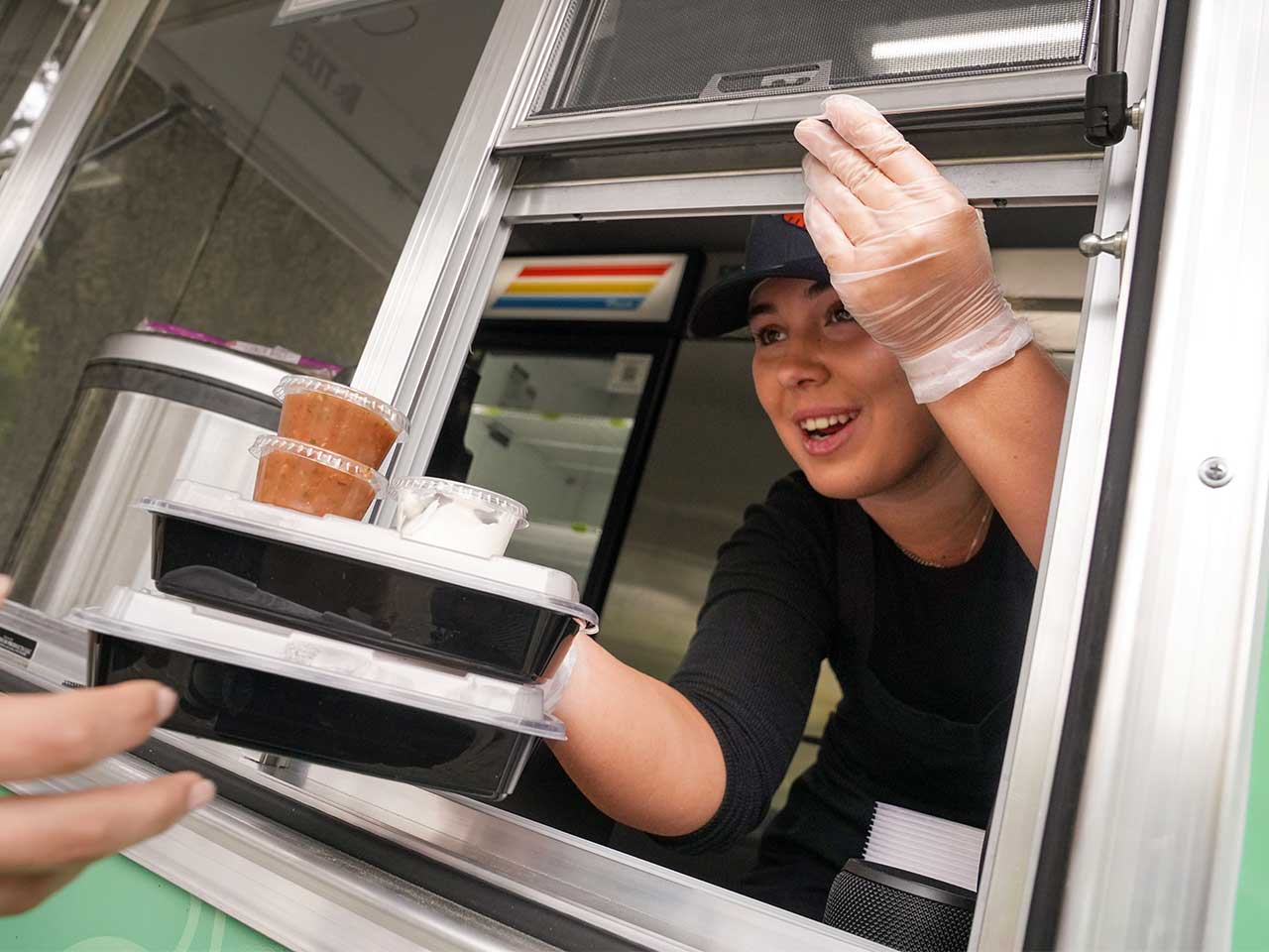 Food science major Bianca Tomad serving food in the Aggie Eats Food Truck at UC Davis.