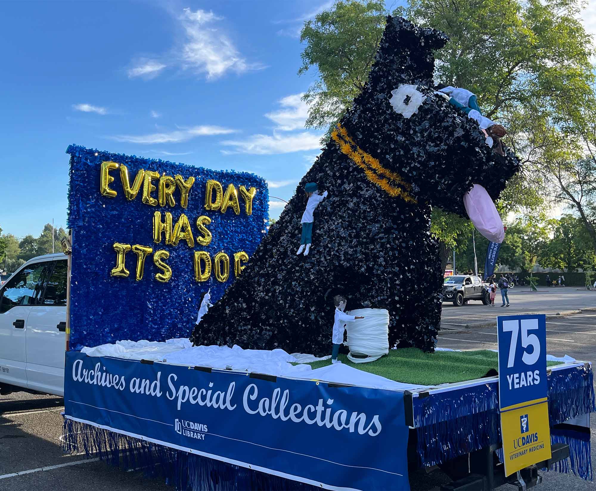 Parade float with dog and text: Every day has its dog