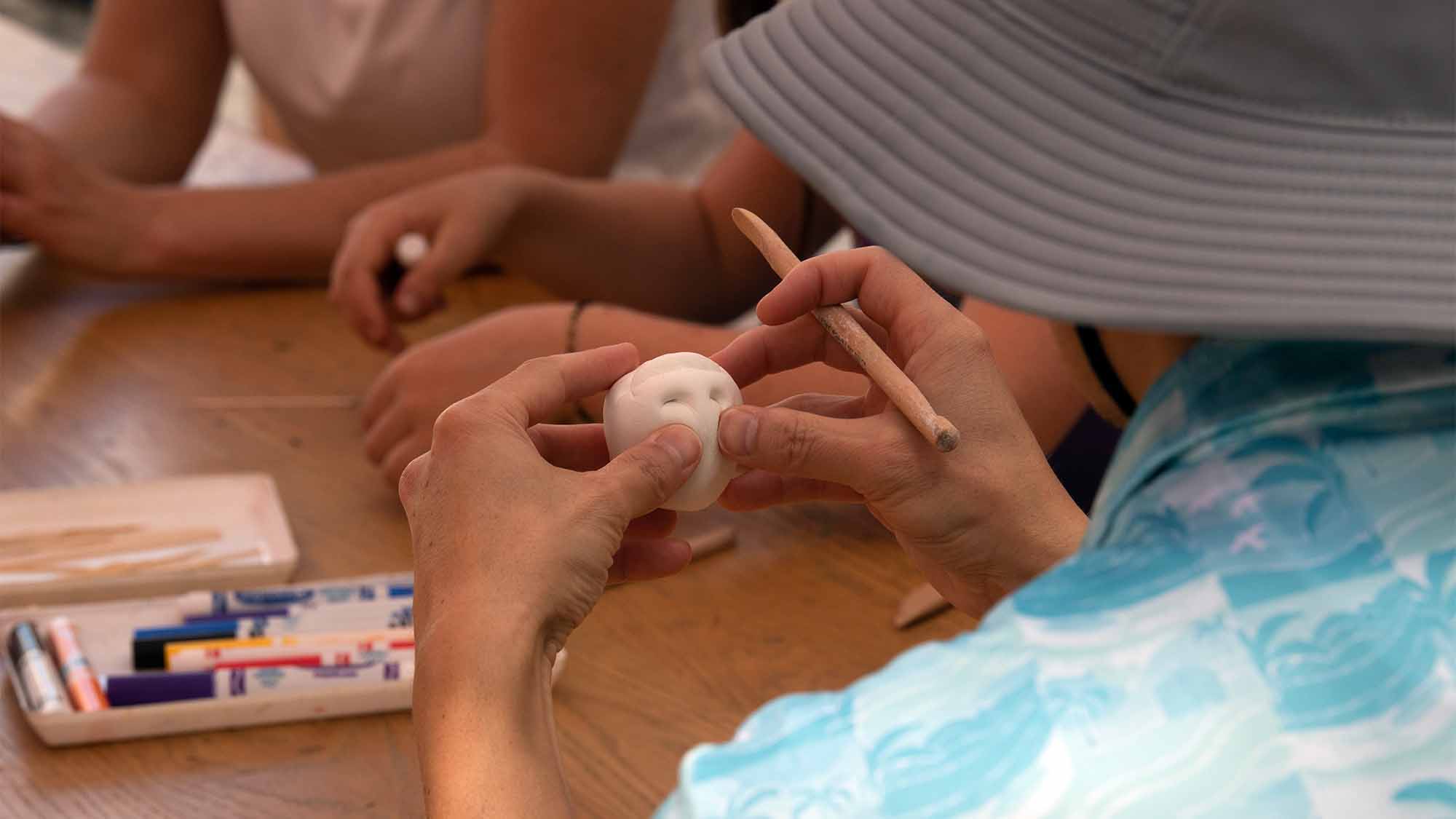Close up photo of miniature clay Egghead sculpture