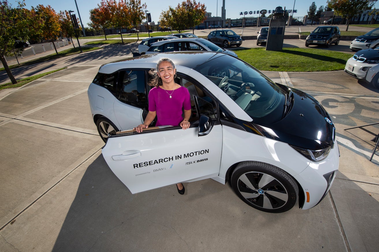 Woman researcher by electric vehicle