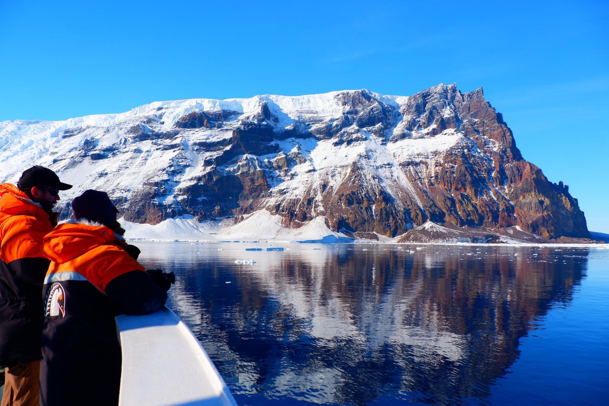 Scientists look over edge of boat in Antarctica