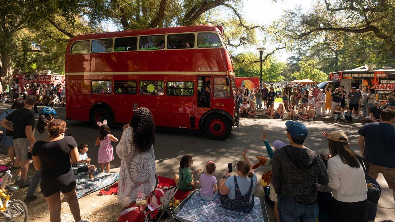 People wave to Unitrans bus in Picnic Day parade