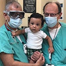 Doctors hold young child