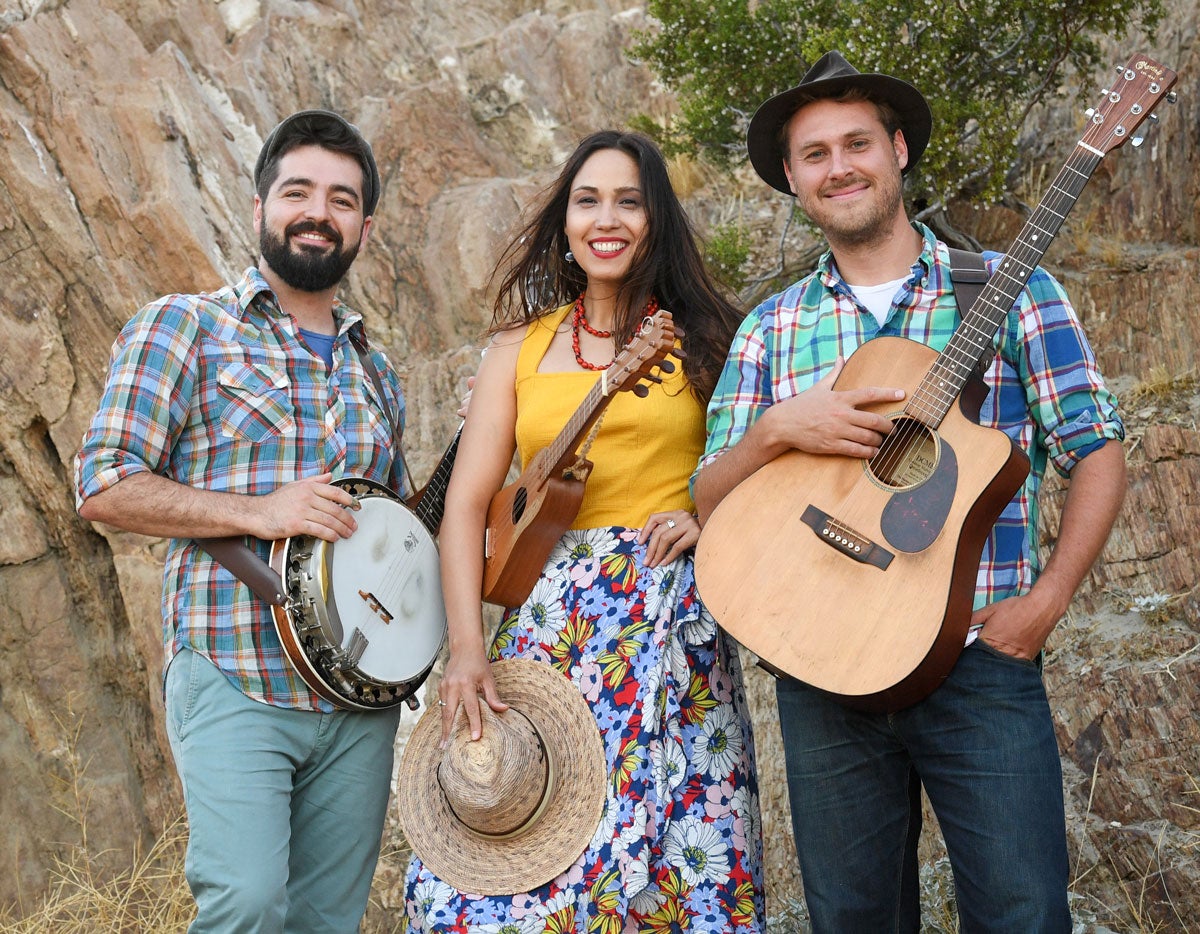 Female singer flanked by two men with banjos.