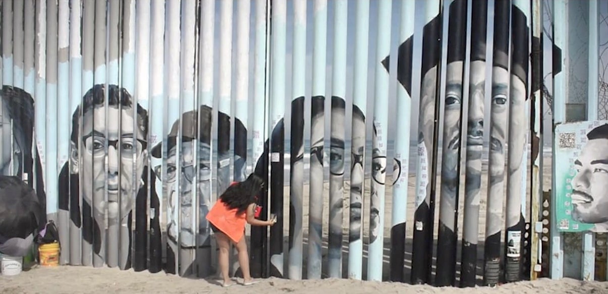 Woman paints a mural