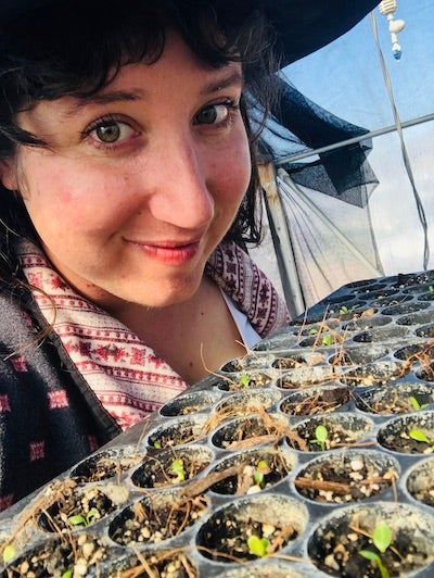 Francesca Claverie poses with seedling.