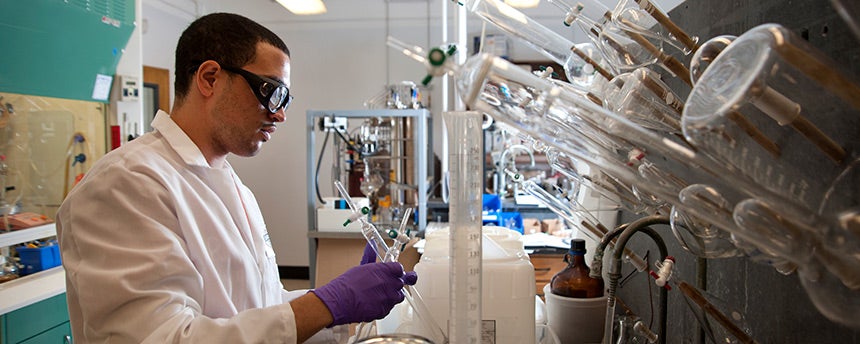 Pharmaceutical chemistry major Manuel Munoz working in a lab