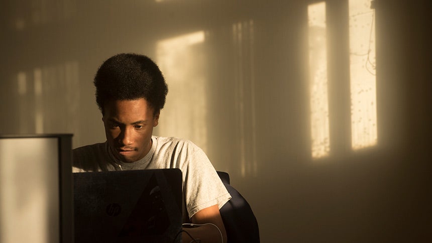 Male student studying in a room