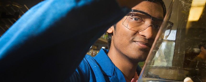UC Davis graduate Srujan Kopparapu ’17 in the lab with a flask