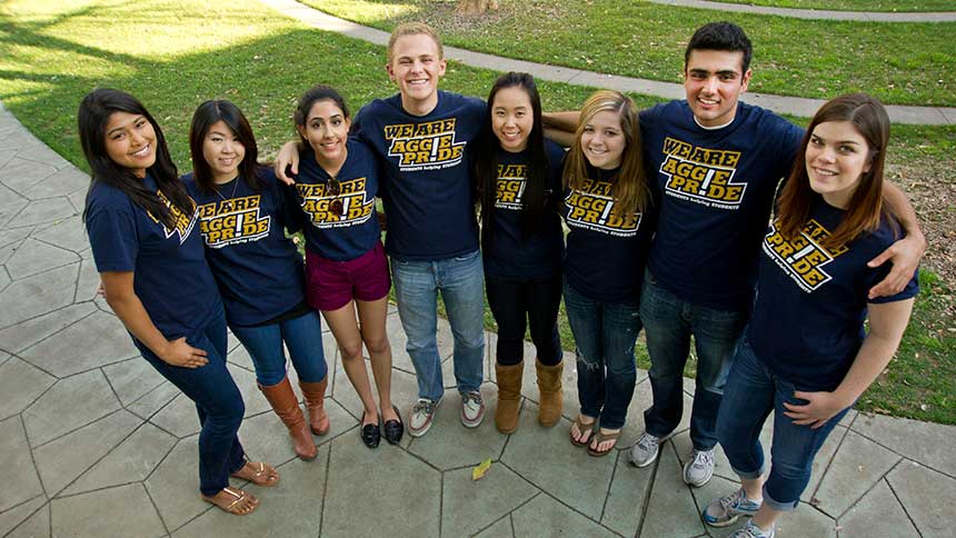 A group of students in a line with Aggie Pride T-shirts