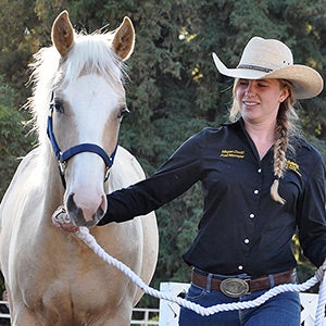 Megan Dodd leading a horse.