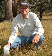 Kenneth Tate in the field with a hat on