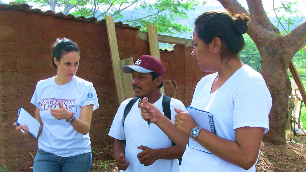 Two veterinarians speaking with a farmer.