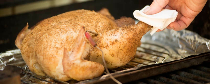 Photo of grilled chicken with meat thermometer