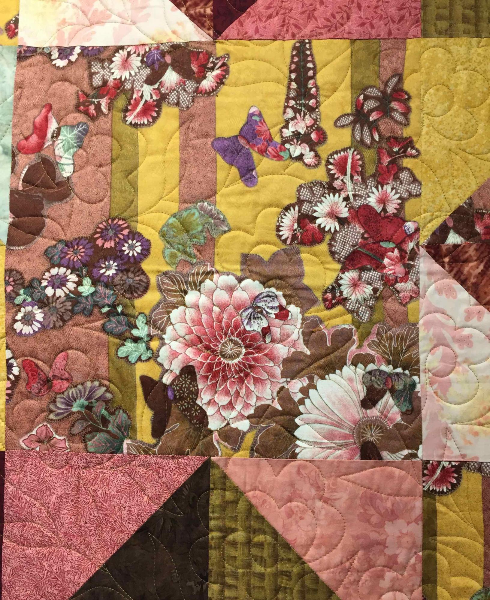 Poulos works initially from a "visual keystone" fabric and builds out. This is the focal point of "Hawaiin Melody" quilt. 