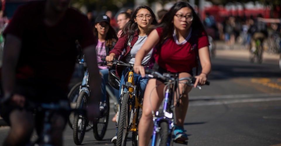 Students ride their bikes on Hutchison Drive on the first day of Fall Quarter 2018.
