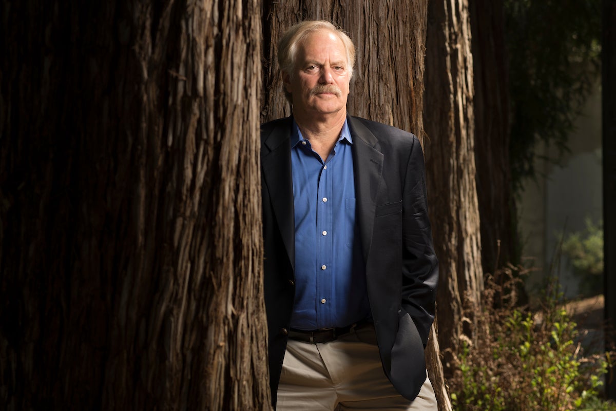 Environmental law professor Richard Frank stands beside a redwood tree in the UC Davis Arboretum.