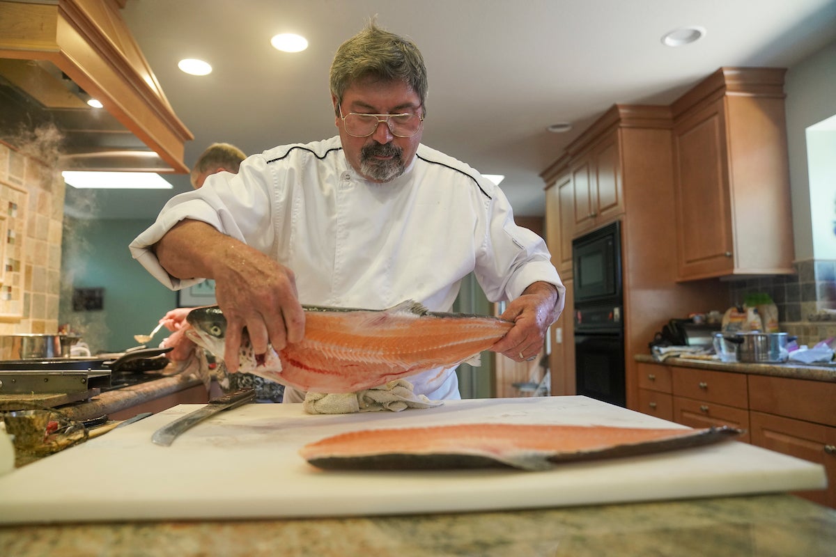 Chef preparing salmon fillets
