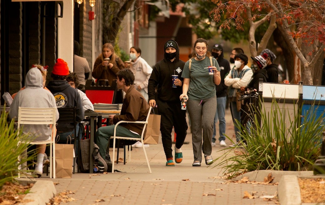 Students at a coffee shop outdoors in downtown Davis