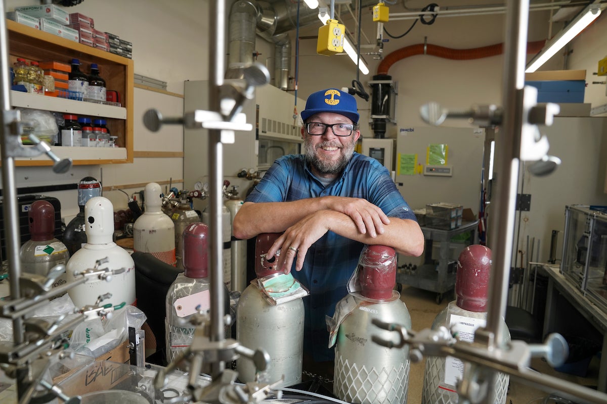 Air quality researcher Keith Bein smiles for profile shot in the lab