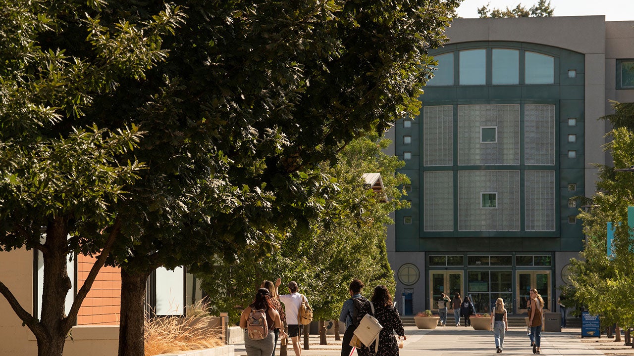 Students. walk on promenade approaching Shields Library at UC Davis