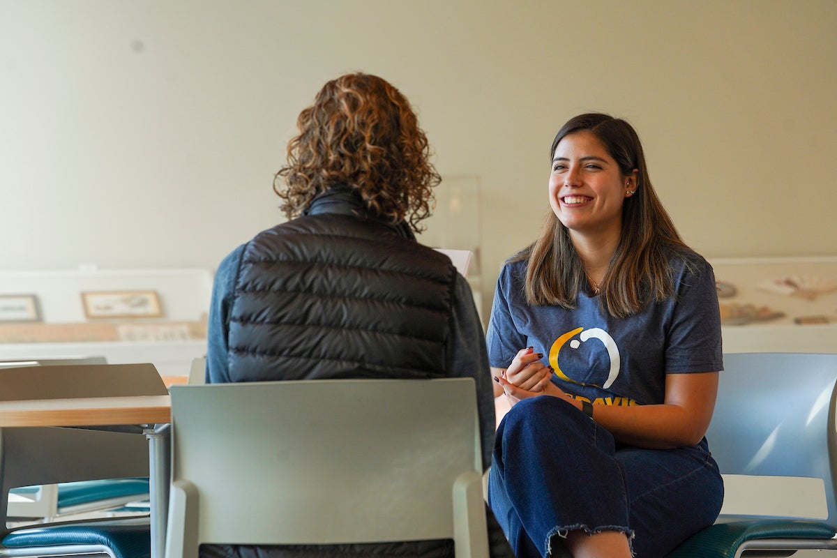 A student sits down with a staff member at UC Davis. 