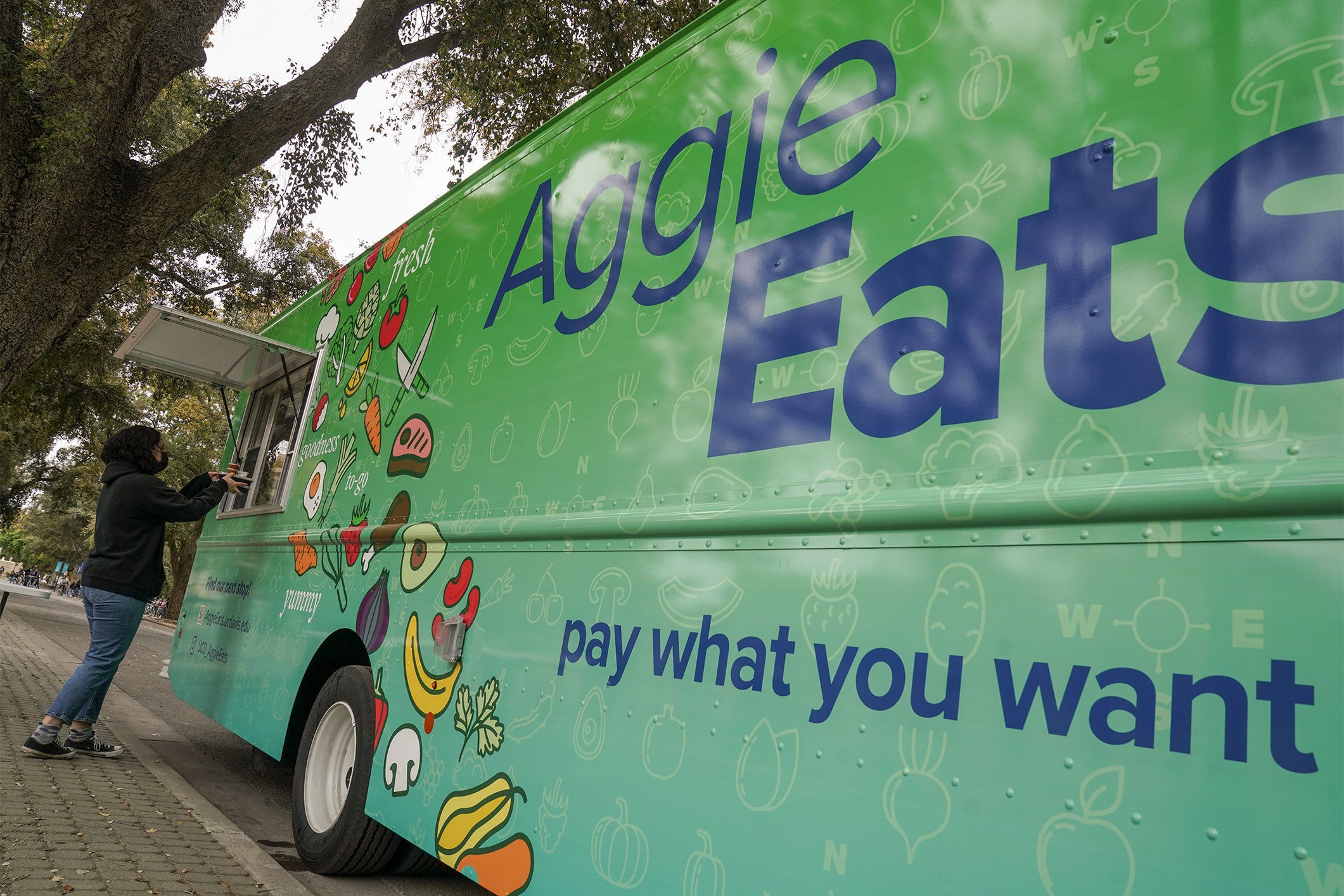 C Davis' "Aggie Eats" food truck offers nutritious meals on a "pay what you want" basis to support food security among students, part of the university's student affairs initiative. (SAMC/UC Davis)