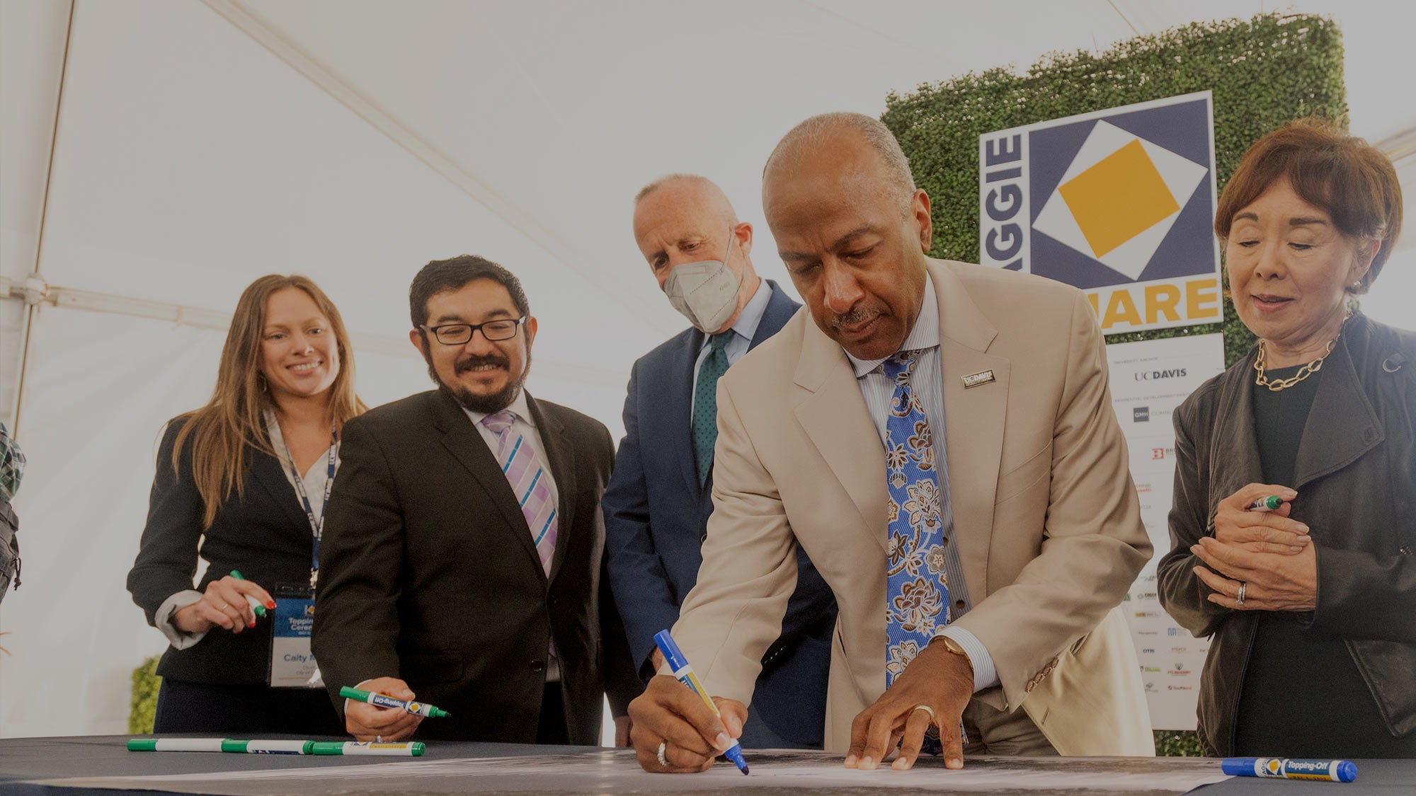 Chancellor May signs Aggie Square poster that will hang in one of the new buildings. Other signatories, from left, Caity Maple, member, Sacramento City Council; Eric Guerra, vice mayor, Sacramento; Darrell Steinberg, mayor, Sacramento; and U.S. Rep. Doris Matsui, D-Sacramento. (Gregory Urquiaga/UC Davis)