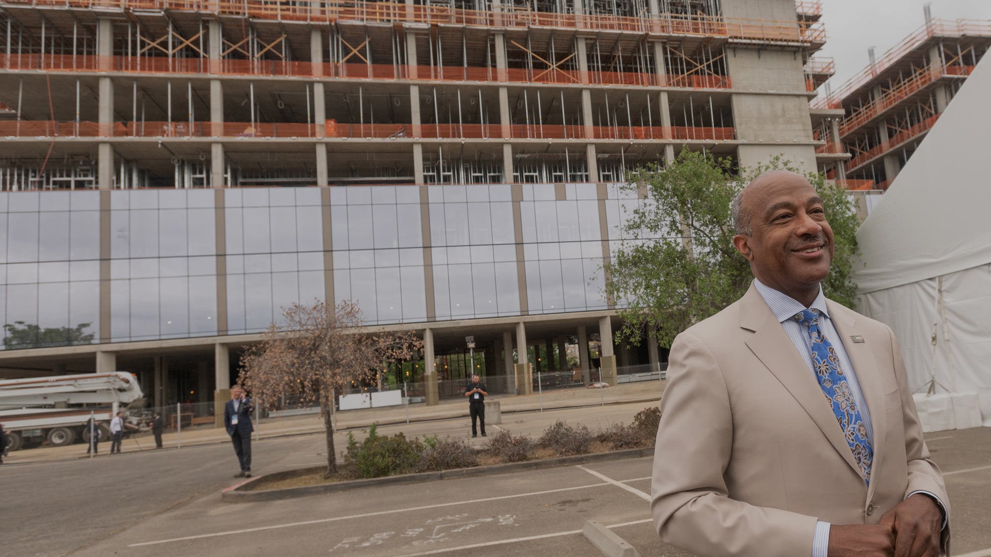 Chancellor Gary S. May smiles proudly in front of the new building under construction, a symbol of growth and progress at UC Davis. (Gregory Urquiaga/UC Davis)