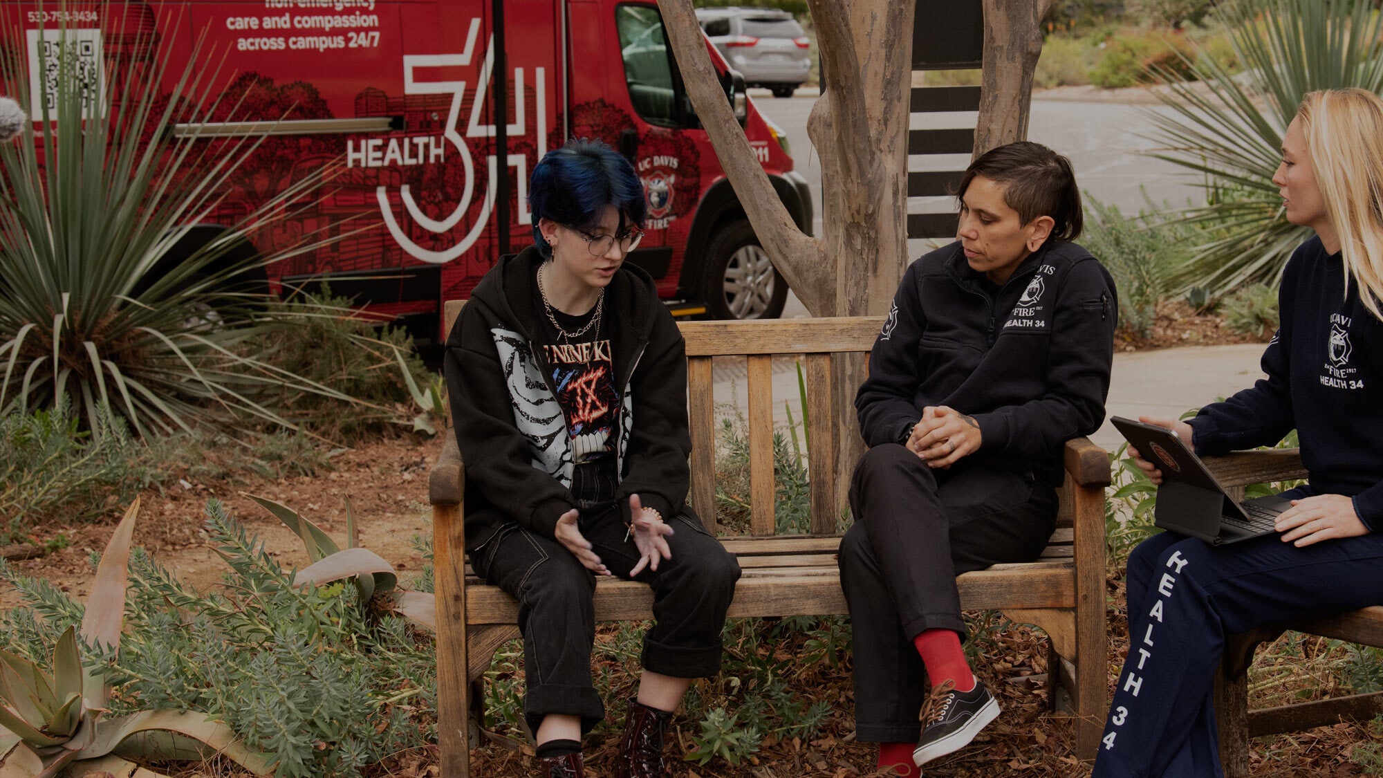 Students and staff demonstrate what a daily Health 34 interaction is like. Sami Tessier engages in a mental health conversation with student Storm and staff member Destiny Rogers in November 2023. (Gregory Urquiaga/UC Davis)