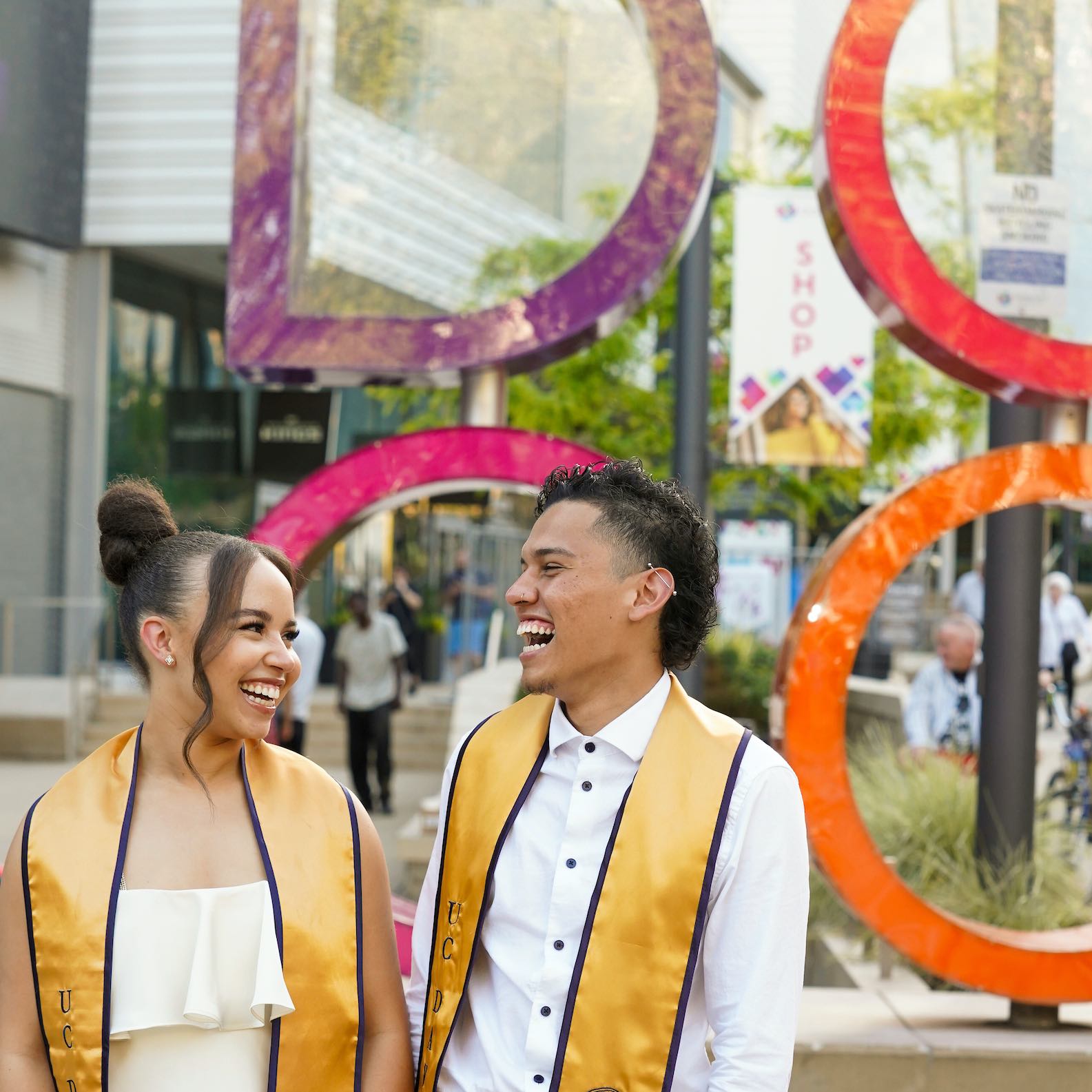 two UC Davis graduates in front of the Golden One Center