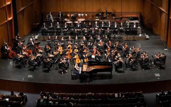 symphony orchestra at UC Davis, on stage with dark background