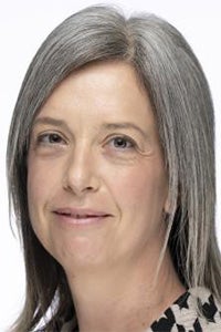 Color headshot of a woman with gray hair and soft smile, white background