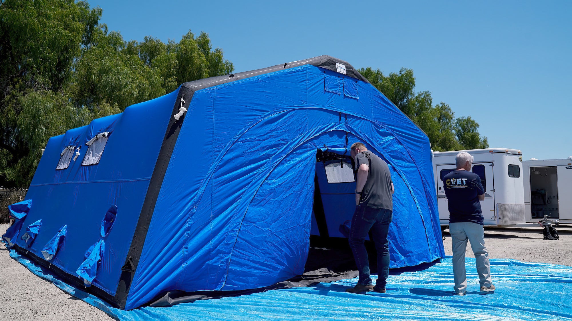 Big blue tent that serves as a temporary structure that can be used to treat animals or shelter personnel at a disaster response site. (Vu Dao / UC Davis)