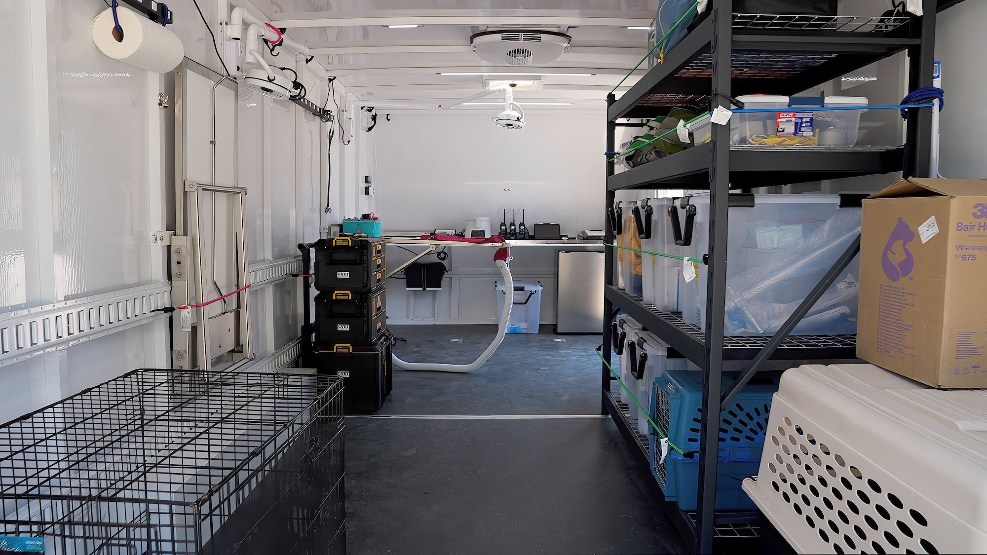 Inside one of the trailers that will serve as a mobile exam room. It holds shelves, kennels, and an exam table. (Vu Dao / UC Davis)