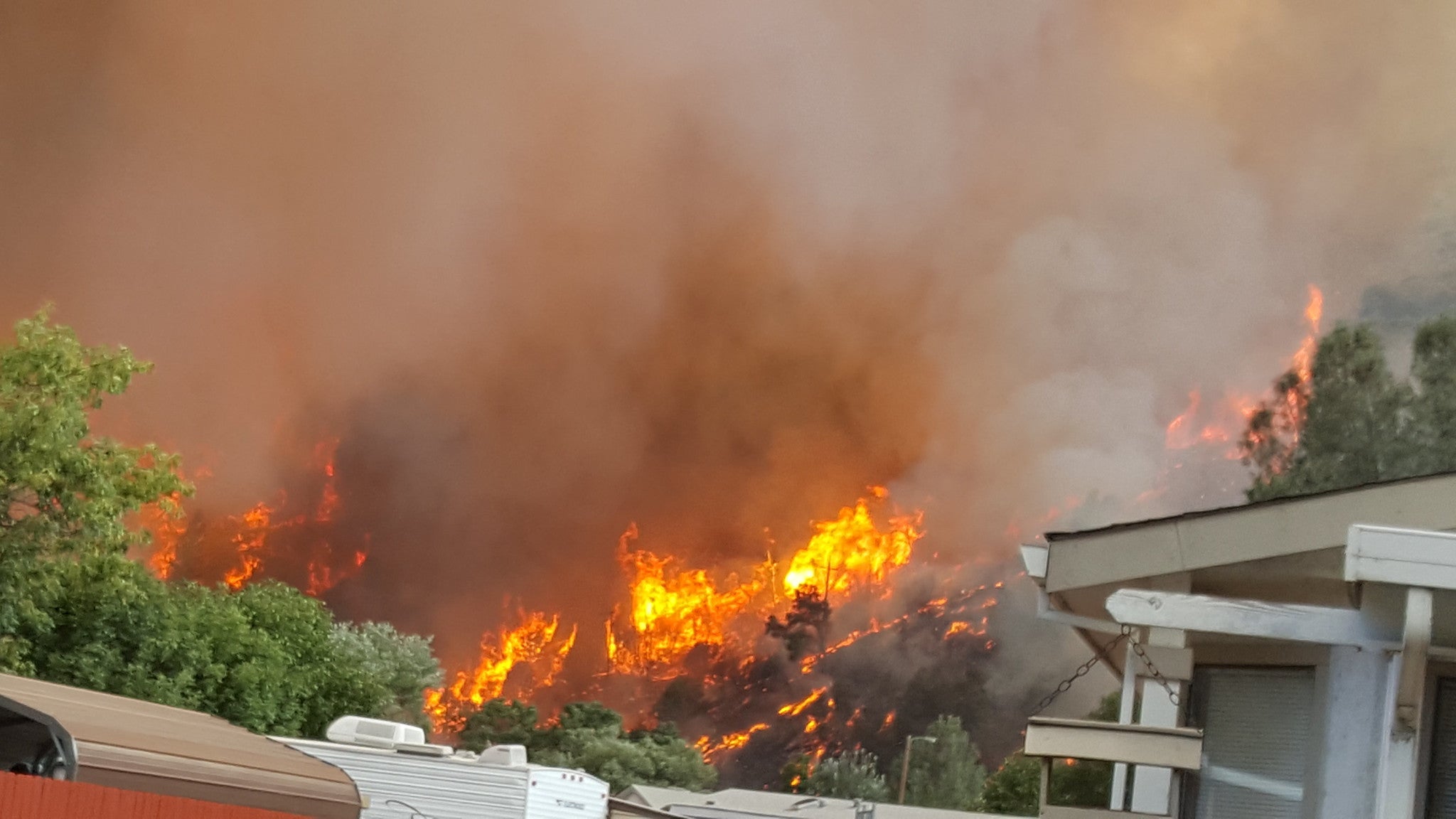 Flames and smoke over houses during the 2018 Carr Fire