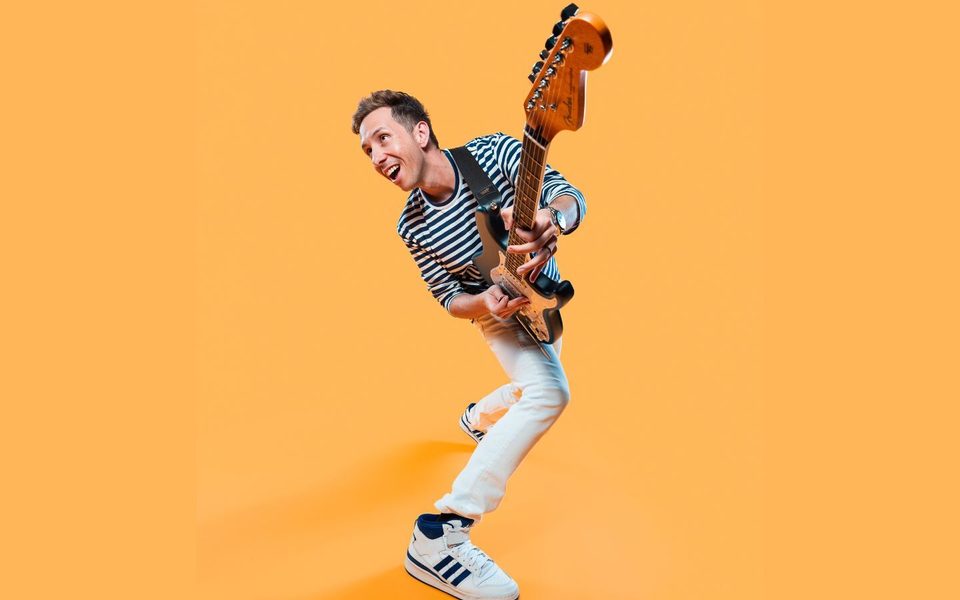 Guitarist, with instrument, on yellow background