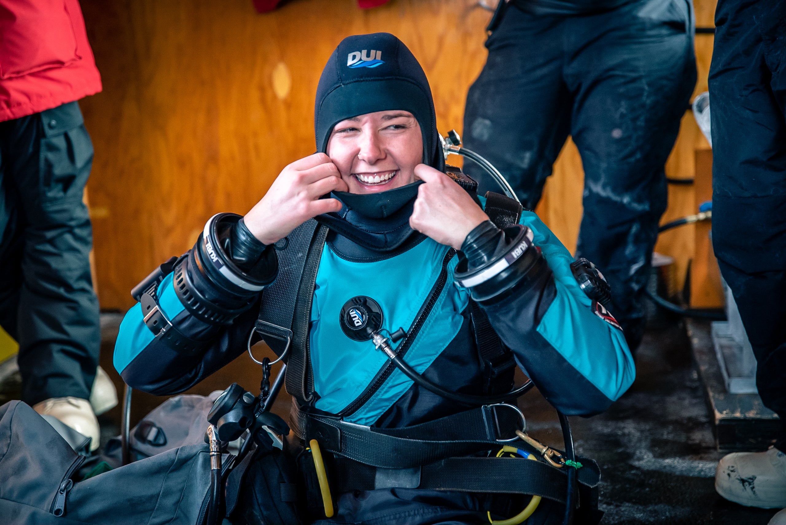 Amanda Frazier in dry suit prepares to enter icy Antarctica water inside diving hut
