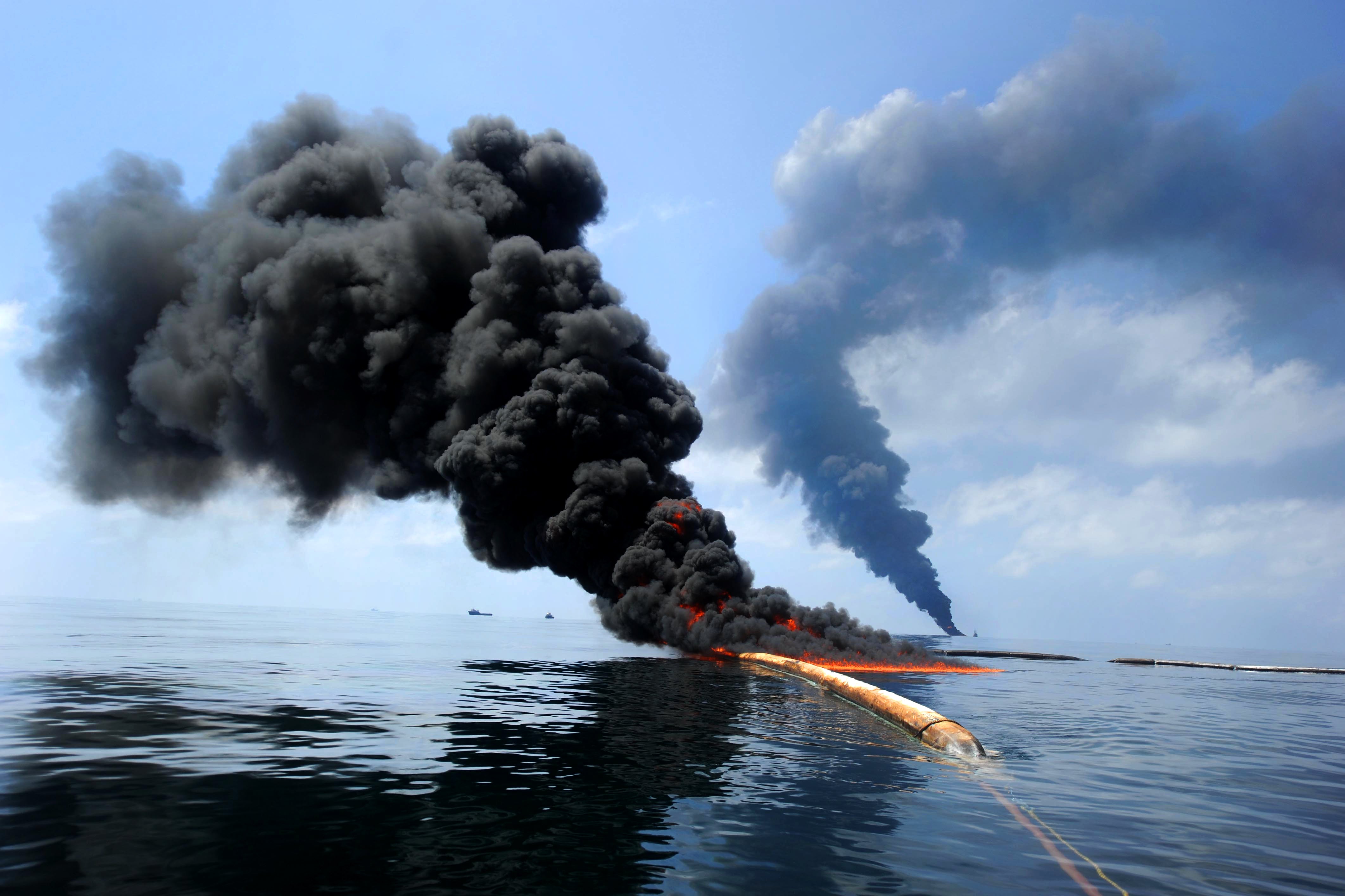 black smoke burns off ocean surface from controlled burn in Gulf of Mexico after oil spill