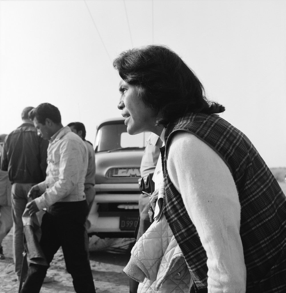 Woman walking in a 1960s black-and-white photograph