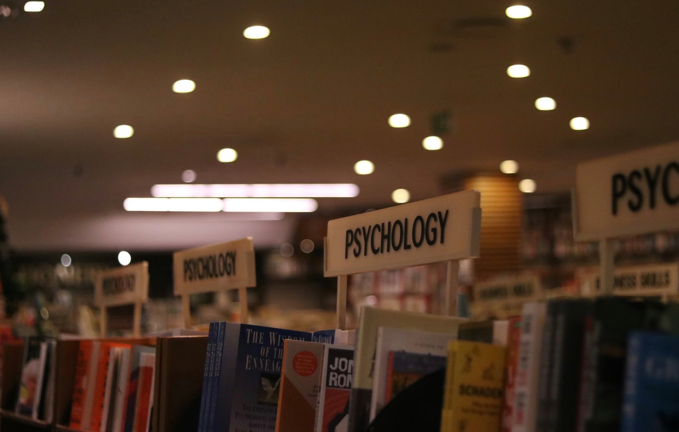 Library photograph of shelves with Psychology section signs and books