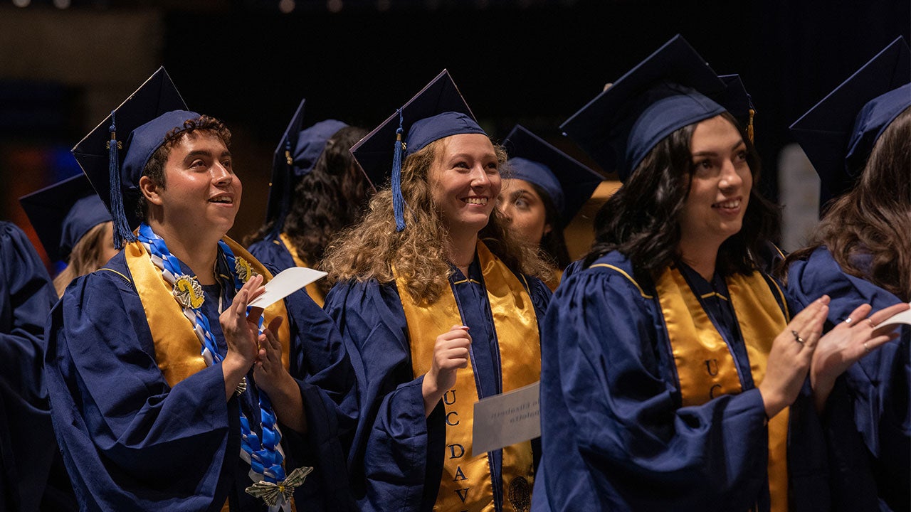 Graduates Ivan Padilla Franco and Abrielle Spaletta clap during the ceremony