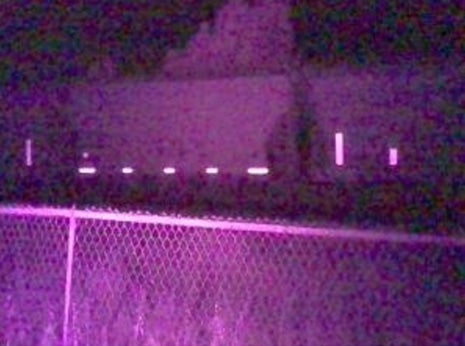 purple infrared light colors nightime shot of paassing coal train car