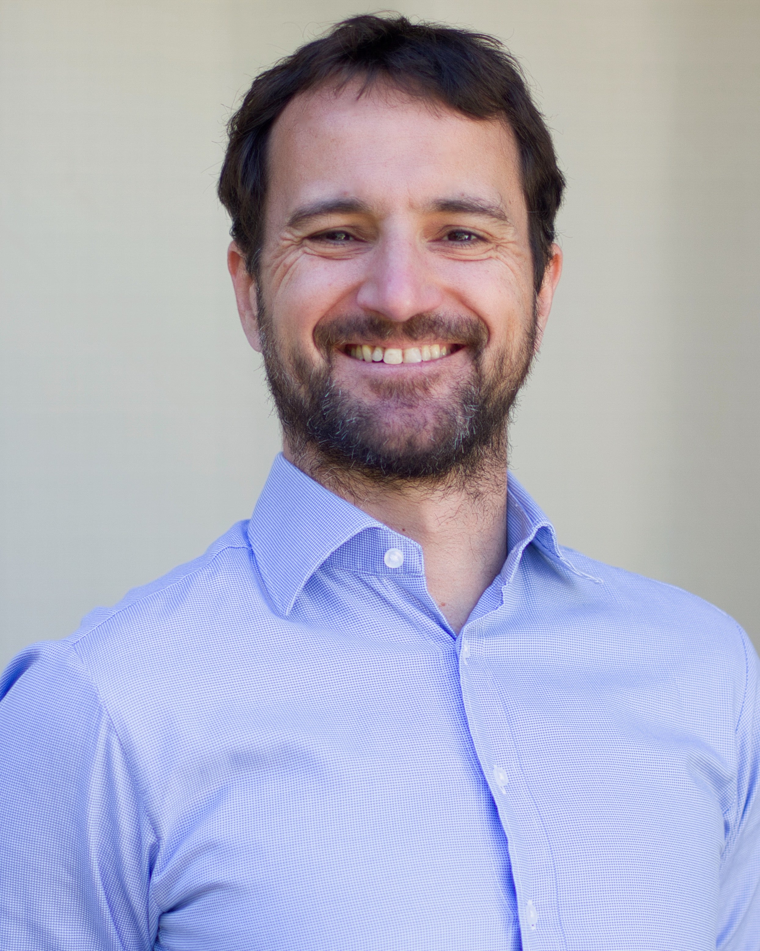 Head shot of UC Davis agronomist Alessandro Ossola, smiling in light blue button-up shirt