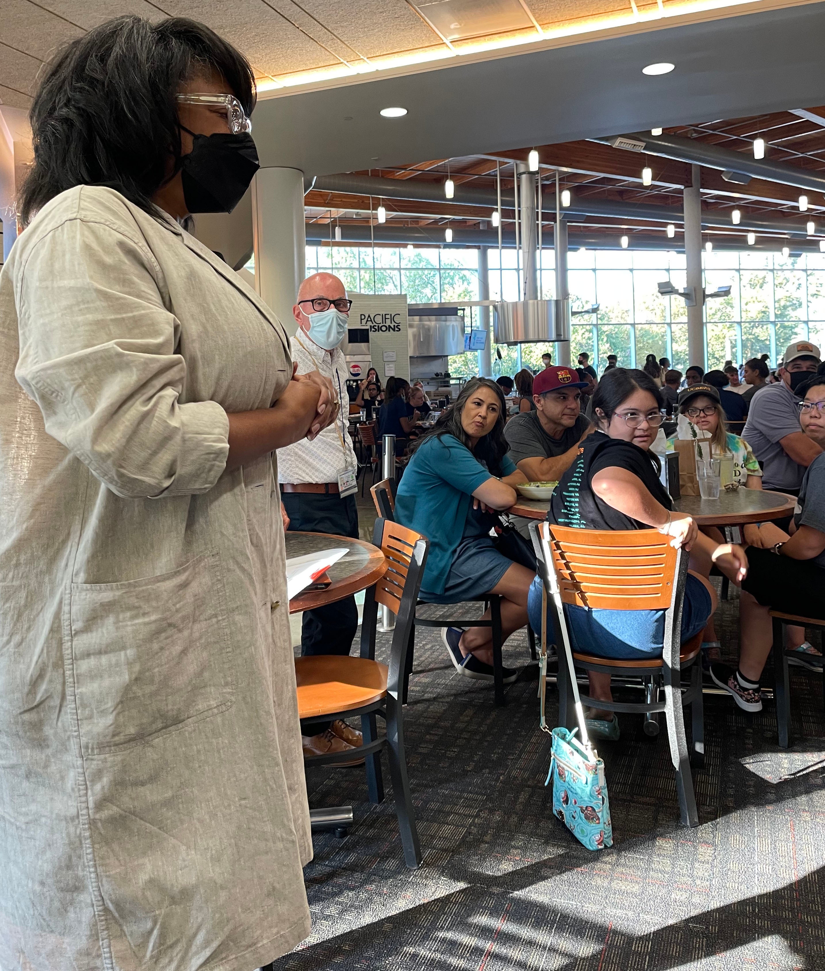 Renetta Tull talks to a crowd in the dining commons