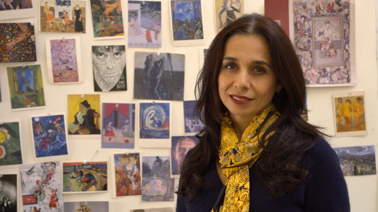 Portrait of woman in front of colorful artwork