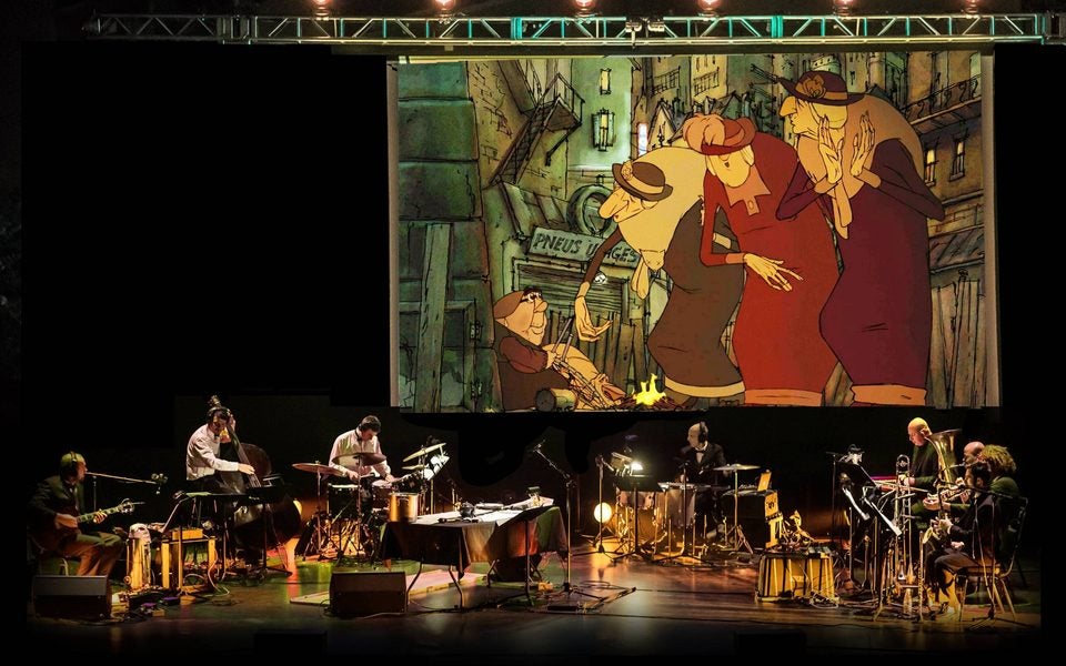 Image of musicians playing in front of cartoon