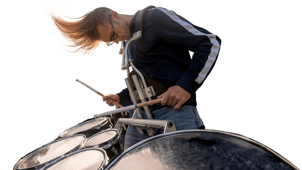 Drummer leaning over marching tenor drums, hair flying