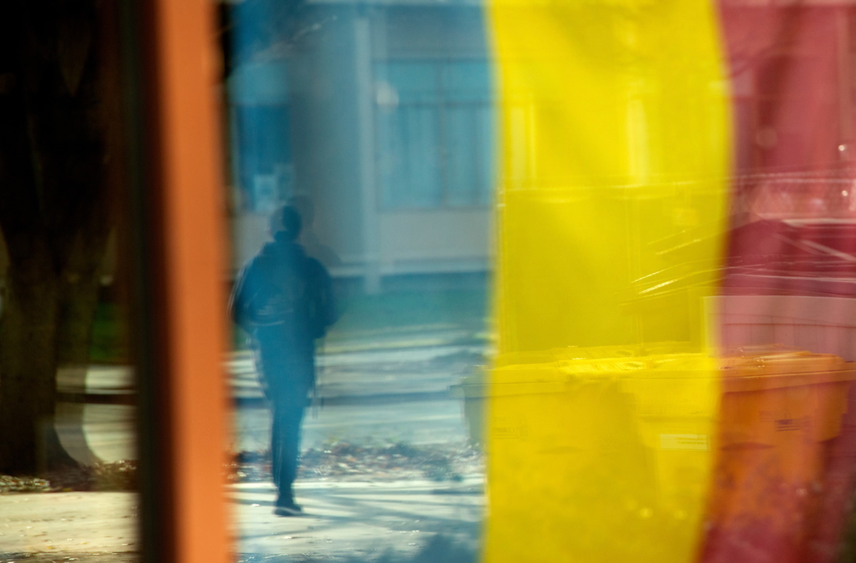 anthropology student walks through colorful flag at uc davis