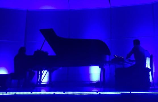 piano silhouetted in blue